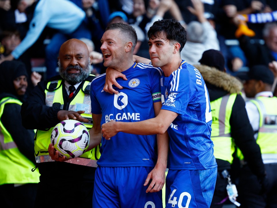 two soccer players wearing blue jerseys with bc game on them