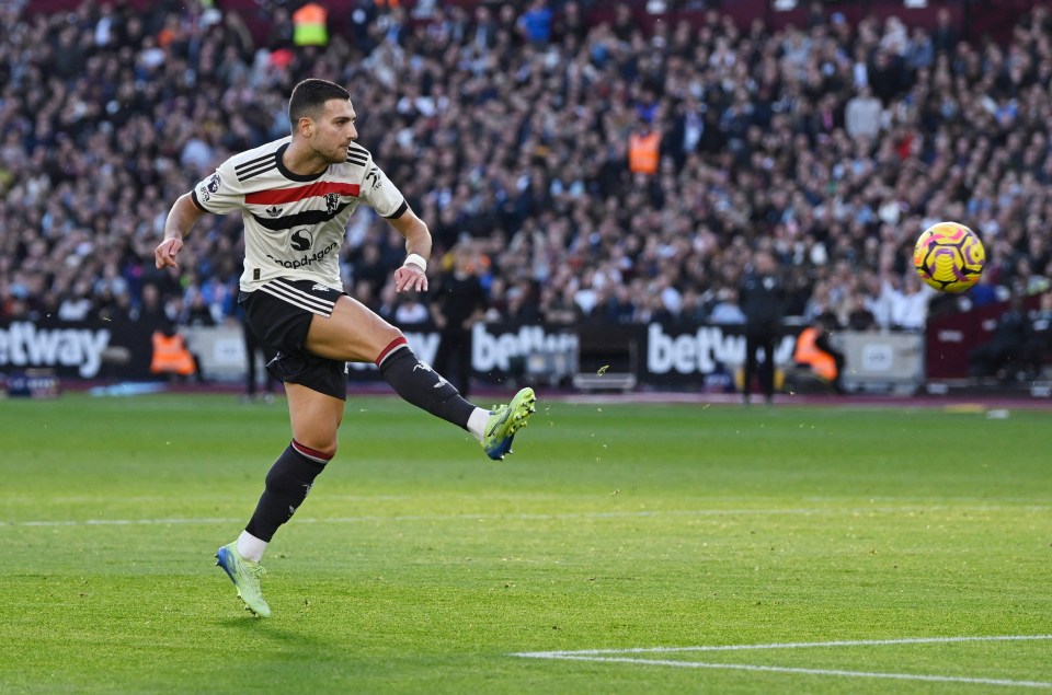 a soccer player kicking a ball with a betway sign in the background