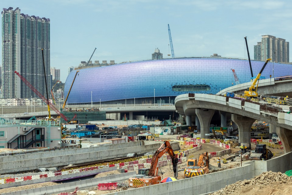 a construction site with a large building in the background