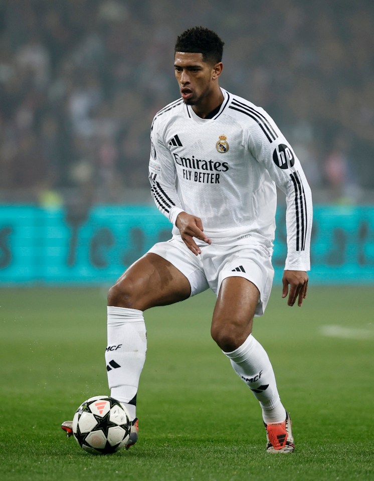 a soccer player wearing a white emirates fly better jersey