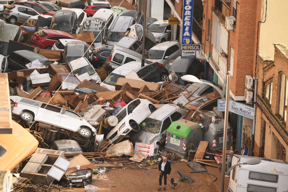 a sign for hersol is above a pile of cars