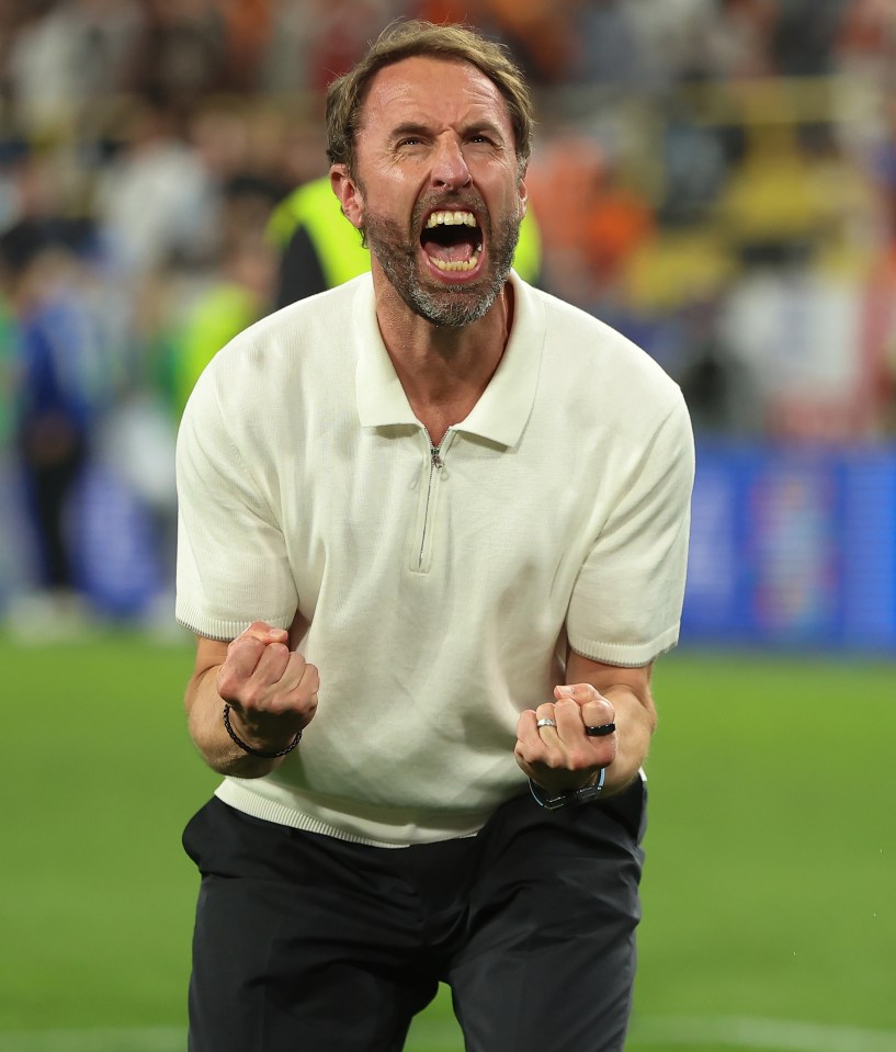 a man in a white shirt is screaming on a soccer field