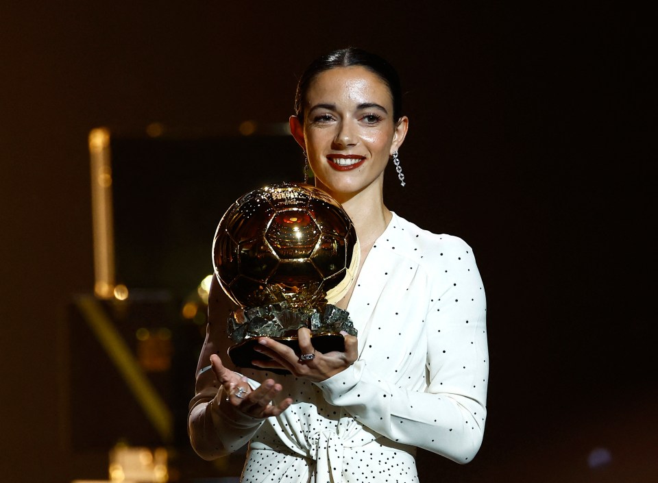 a woman in a white dress is holding a soccer ball