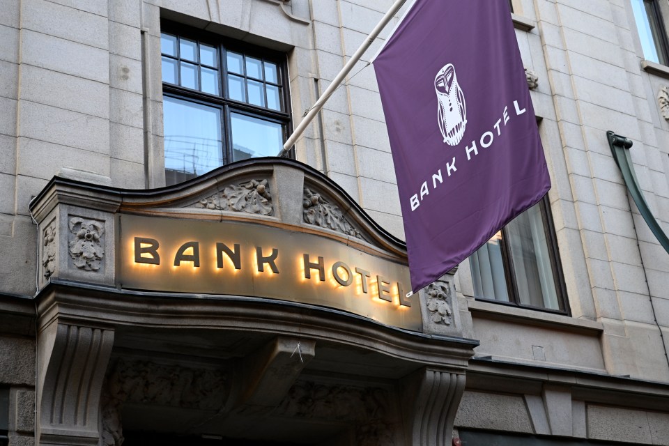 a bank hotel sign with a purple flag hanging from it