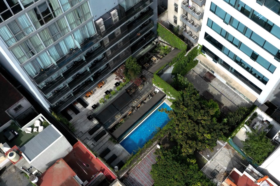 an aerial view of a swimming pool surrounded by buildings