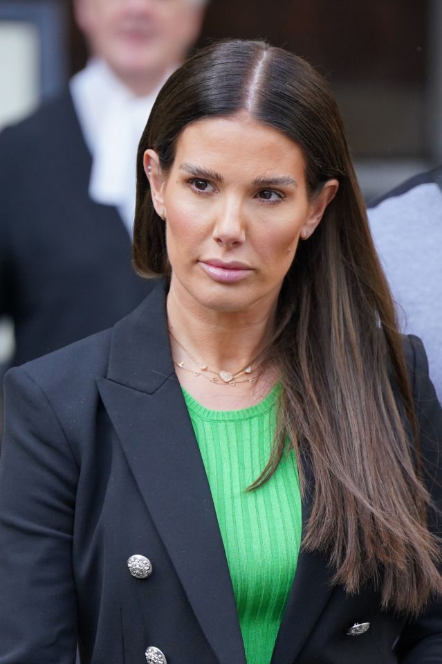 a woman wearing a green top and a black jacket