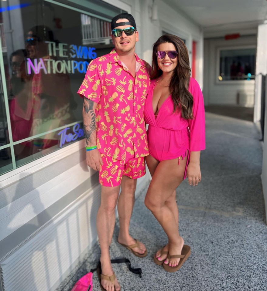 a man and woman standing in front of a window that says the swing nation