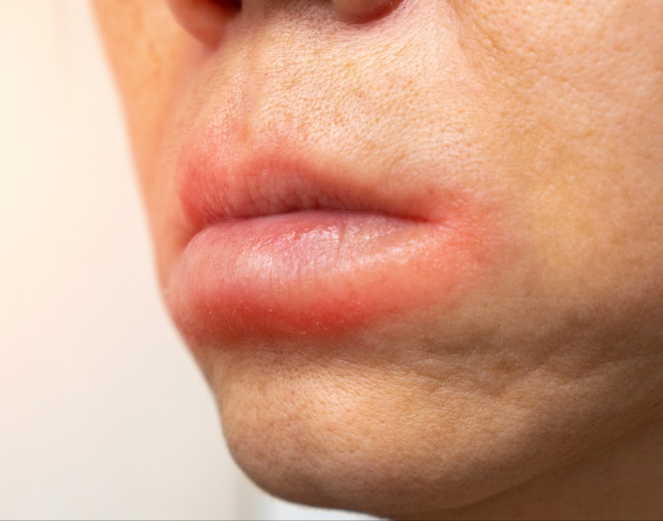 a close up of a woman 's mouth with red lips