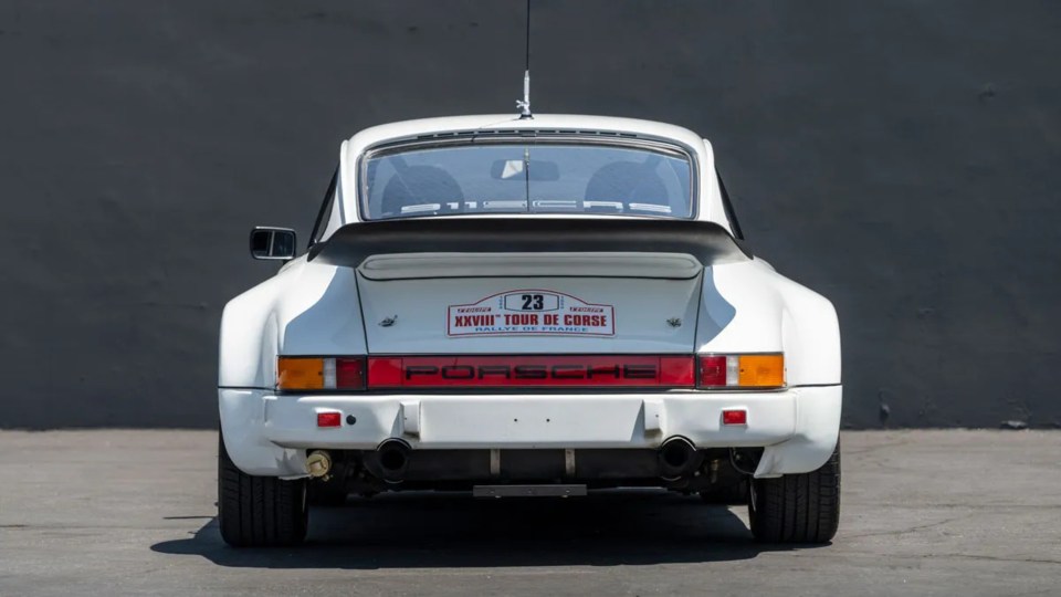 a white porsche with the number 23 on the back