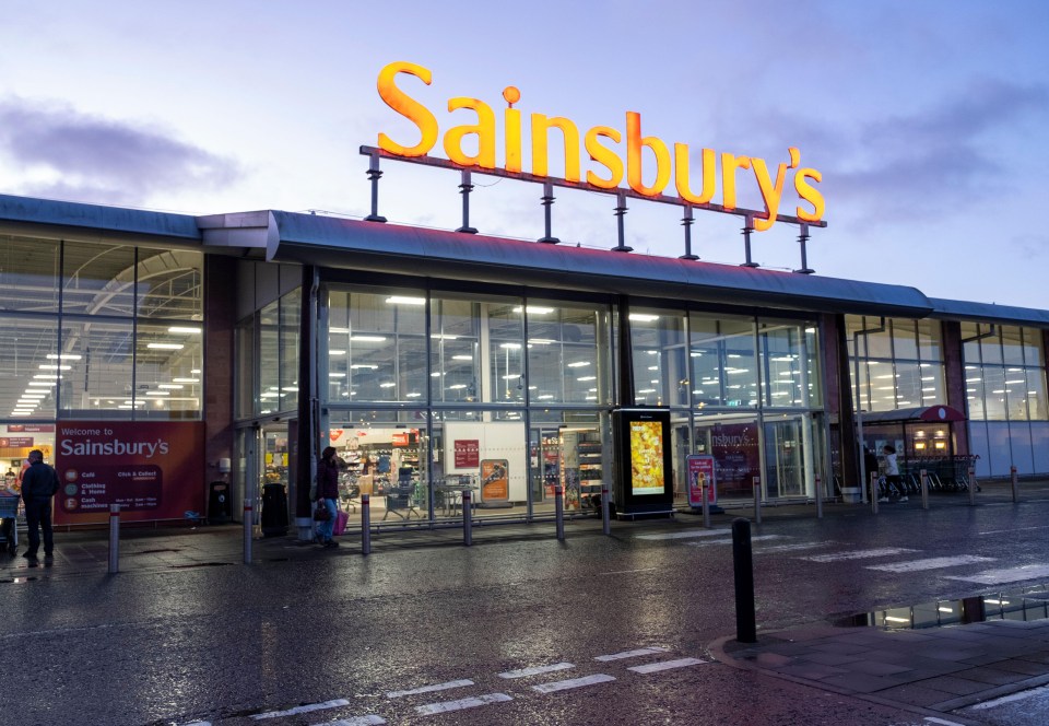 a sainsbury 's store is lit up at night