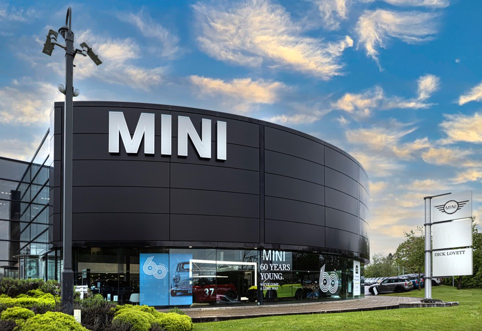 a mini car dealership with a sign that says mini 60 years young