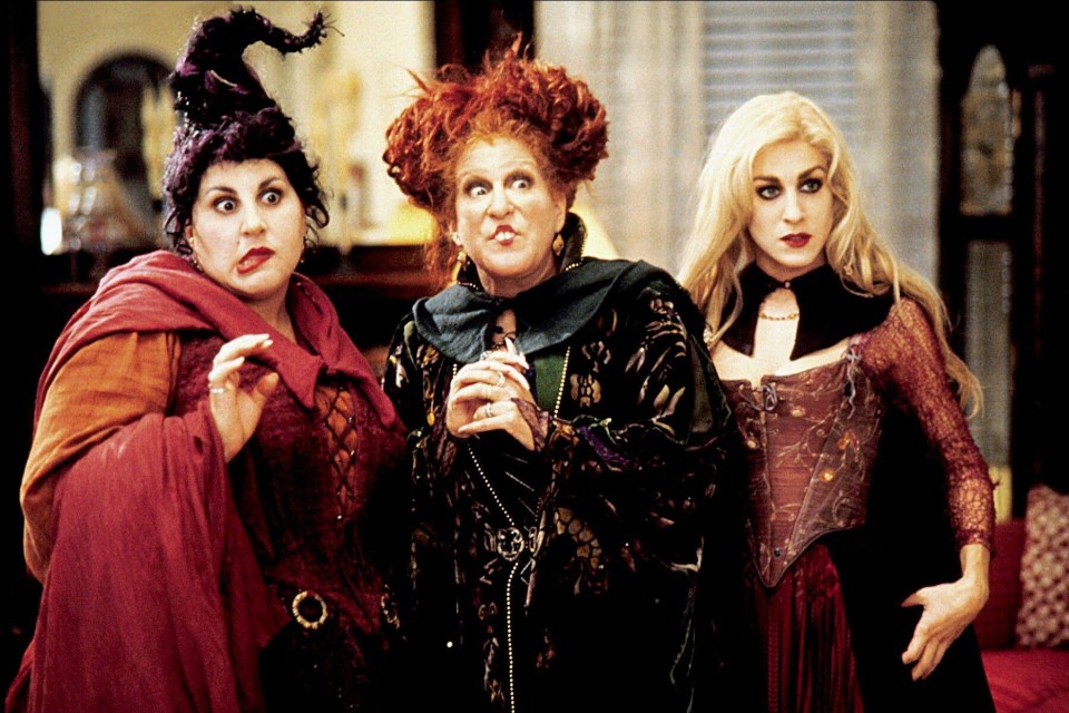 three women dressed as witches are standing next to each other