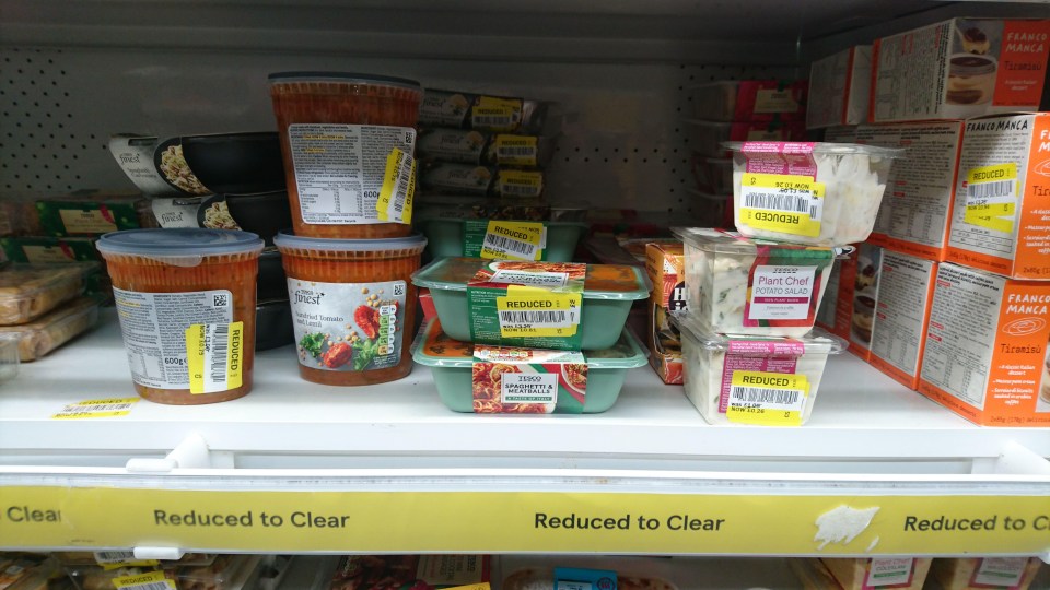 a shelf in a store with a yellow sign that says reduced to clear