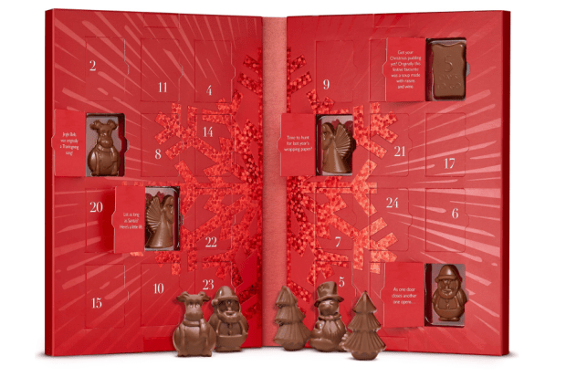 a red christmas advent calendar with a green background