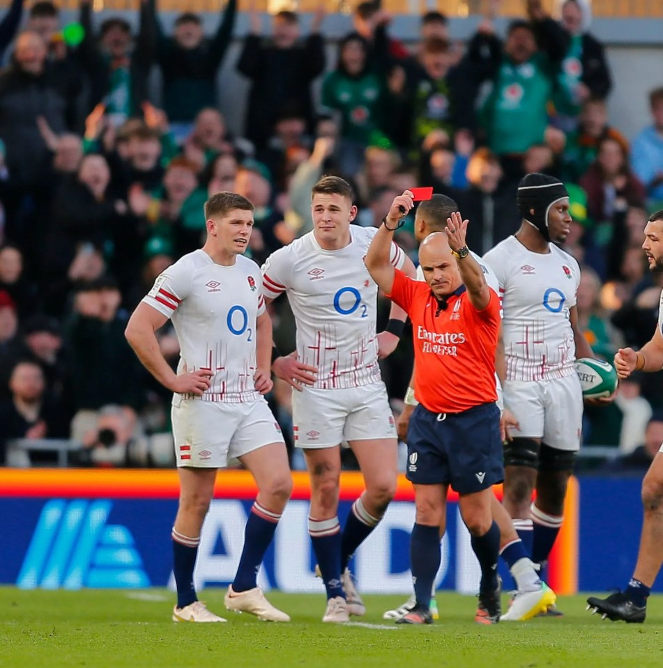 a referee gives a red card to a rugby player