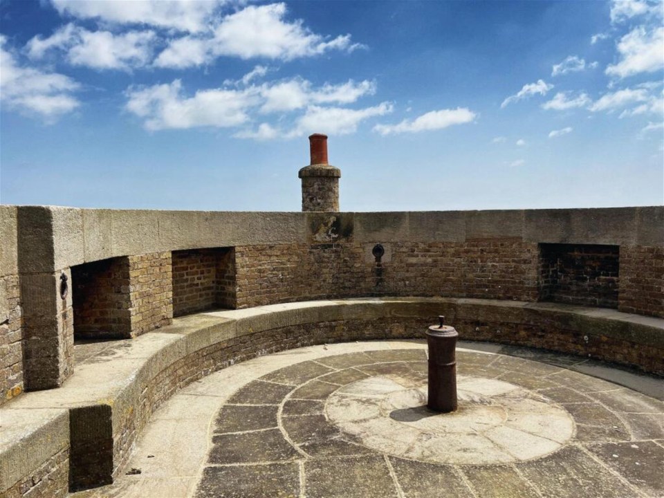 a brick building with a chimney on top of it