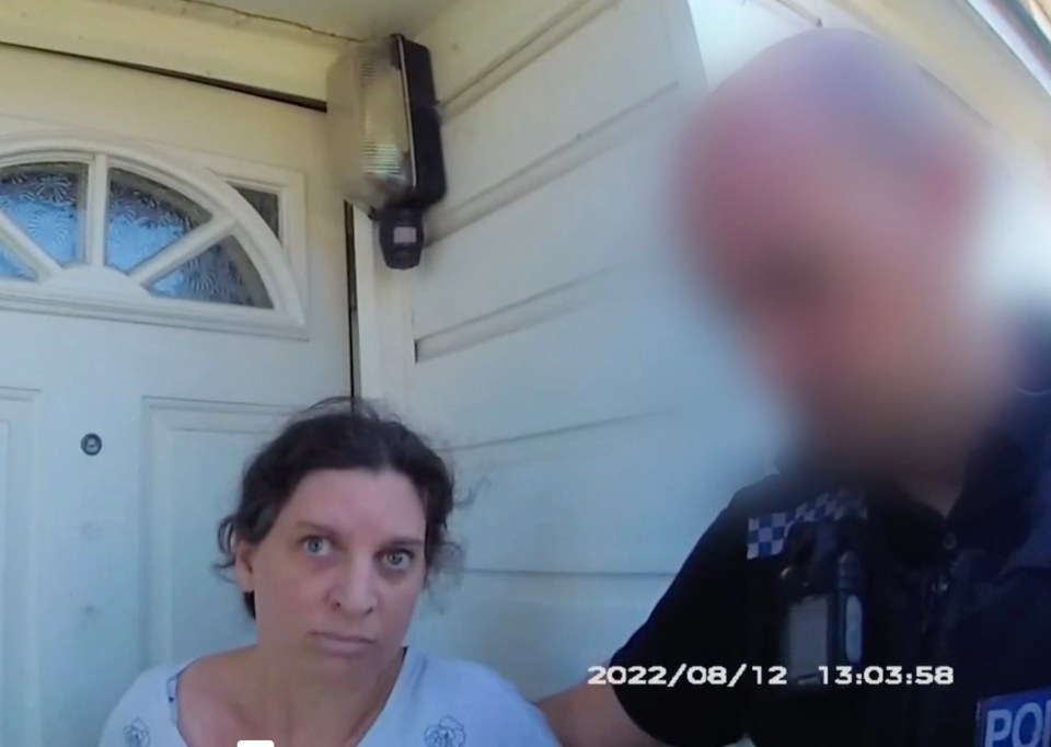 a police officer is talking to a woman in front of a door