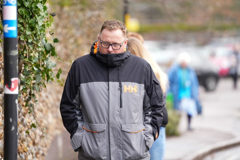 a man wearing a jacket that says hh on it