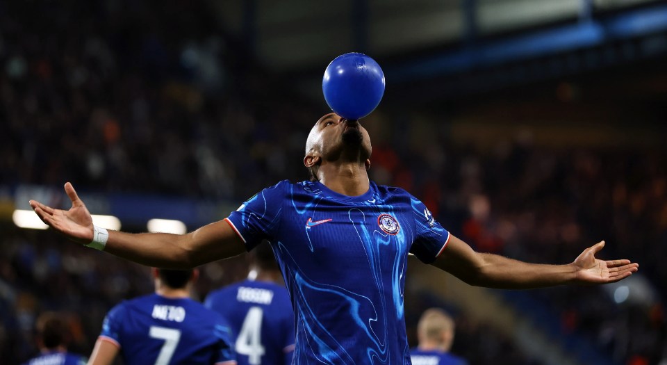 a soccer player with a blue balloon in his mouth