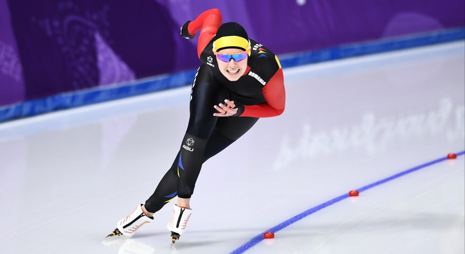 a person is skating on a track with the word pyeongchang in the background