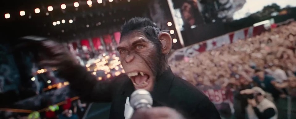 a monkey in a suit is singing into a microphone