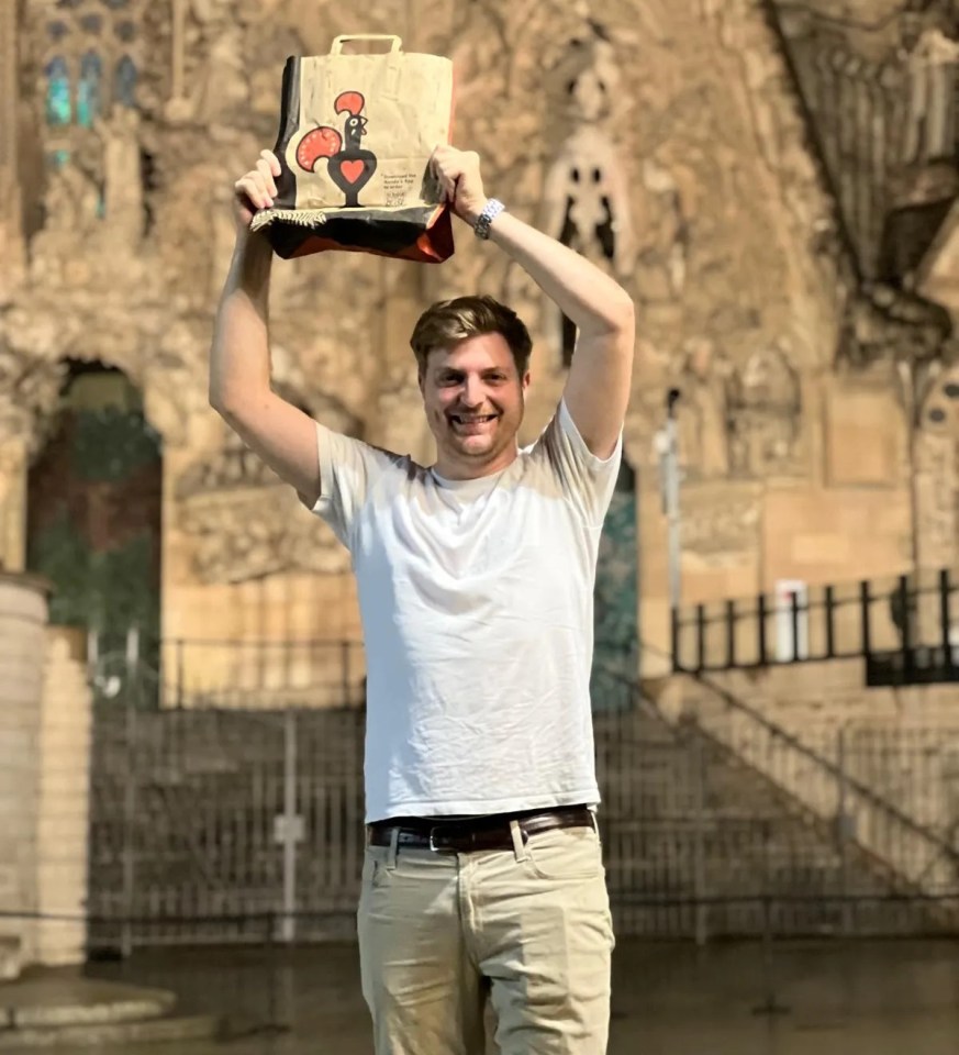 a man holds up a bag with a rooster on it