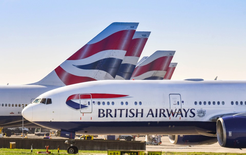 three british airways planes are parked on the tarmac