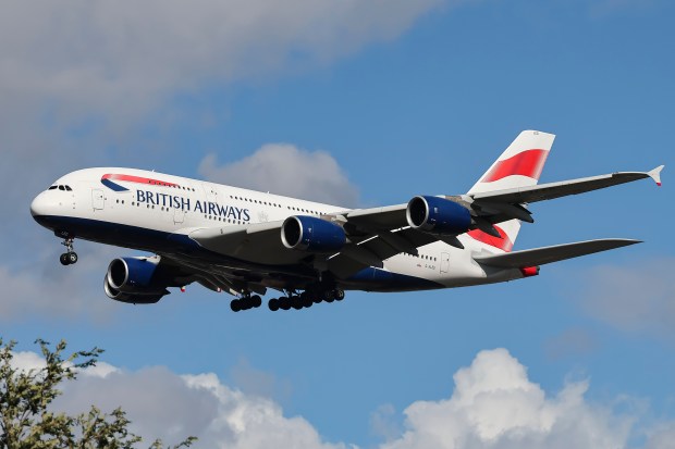 a british airways plane is flying in the sky