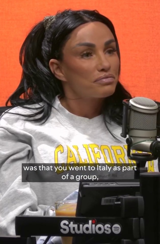 a woman wearing a california sweatshirt sits in front of a microphone