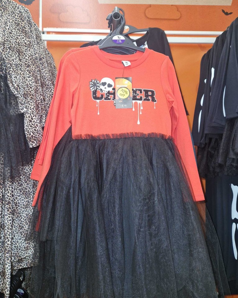 a happy halloween sign hangs above a cheer dress