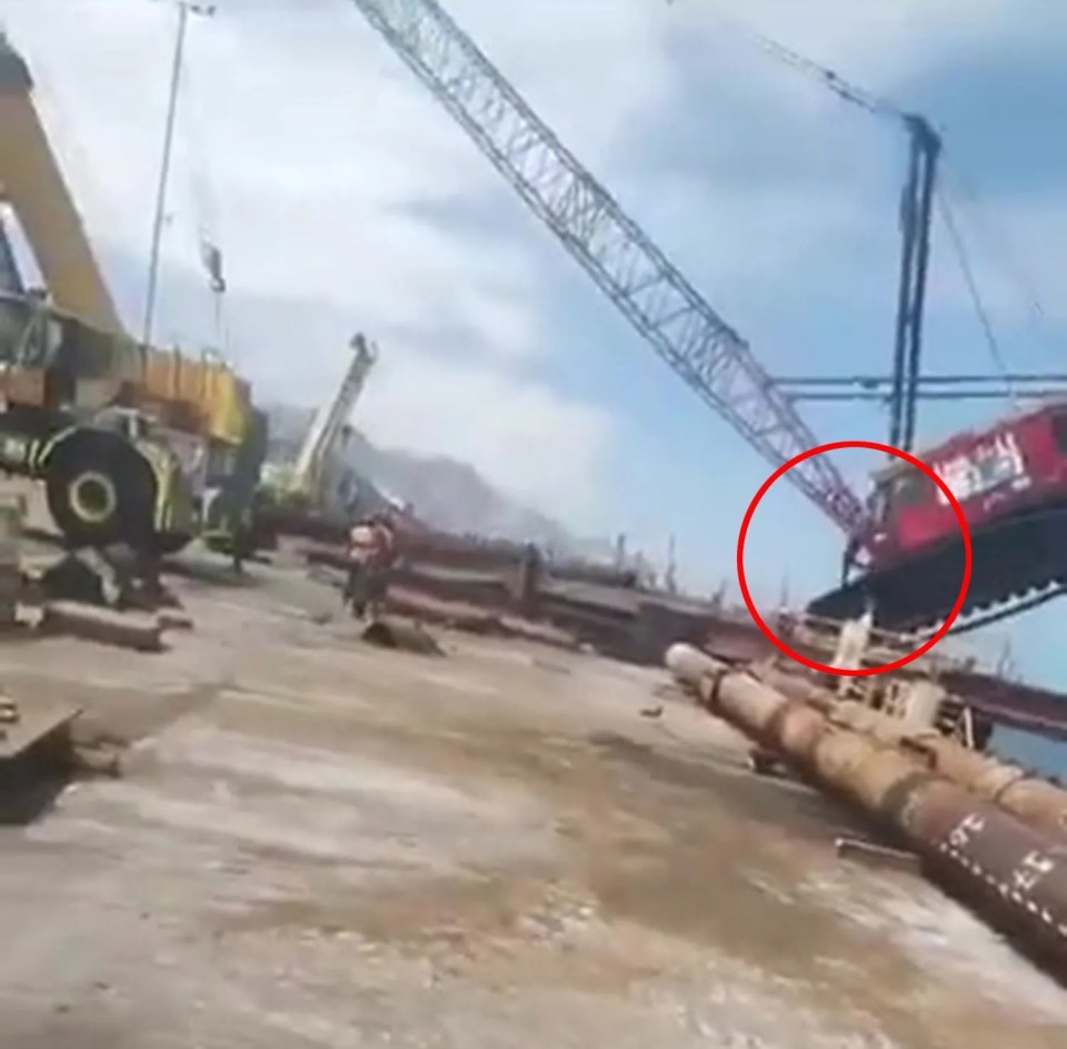 a red crane with a circle around it that says ' a ' on it