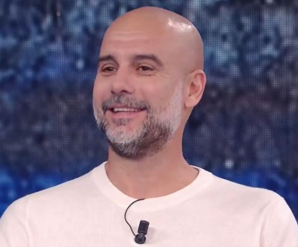 a bald man with a beard is smiling and wearing a white shirt