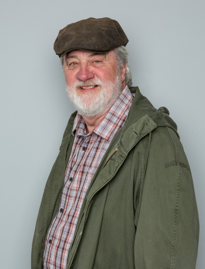 a man wearing a hat and a green jacket that says armer france