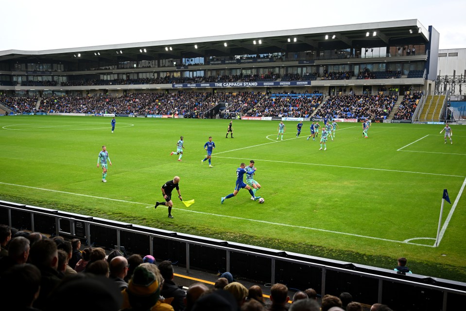 WIMBLEDON, ENGLAND - OCTOBER 12: General view inside the stadium, Callum Maycock of AFC Wimbledon is challenged by Cameron Harper of Carlisle United during the Sky Bet League Two match between AFC Wimbledon and Carlisle United at The Cherry Red Records Stadium on October 12, 2024 in Wimbledon, England. (Photo by Harry Murphy/Getty Images)