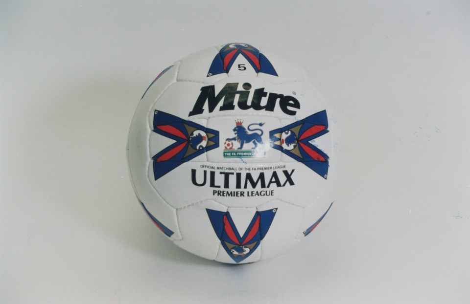 a white and blue mitre ultimax premier league soccer ball