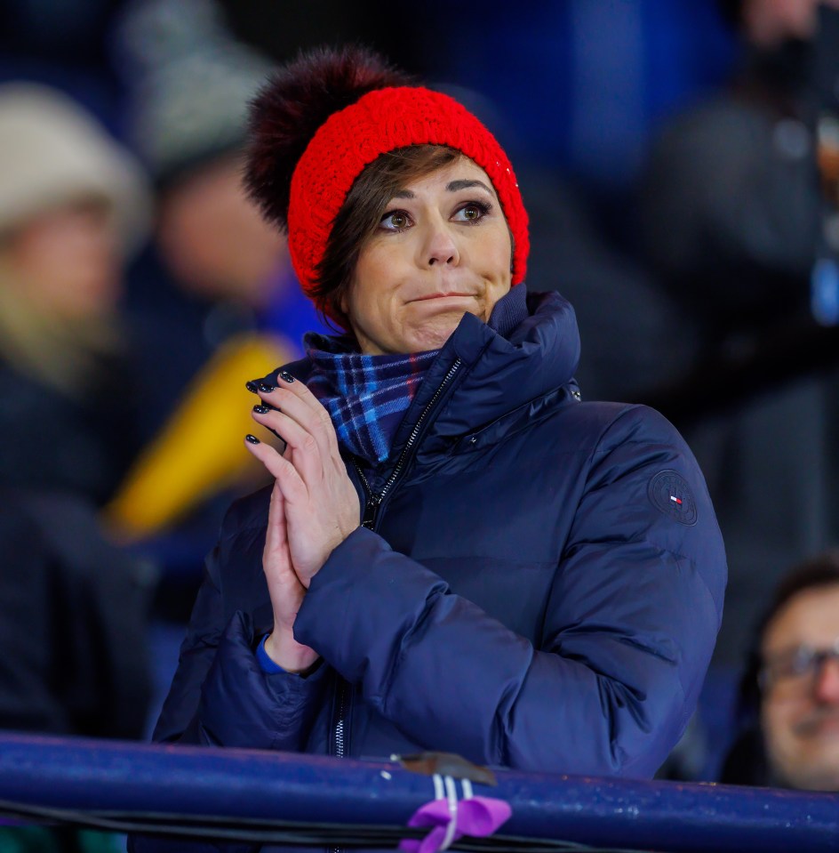 a woman wearing a blue jacket and a red hat