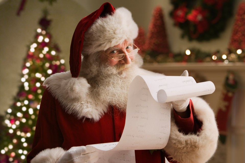 santa claus is reading a list of children 's wishes