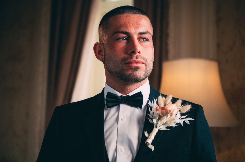 a man in a tuxedo with a flower on his lapel