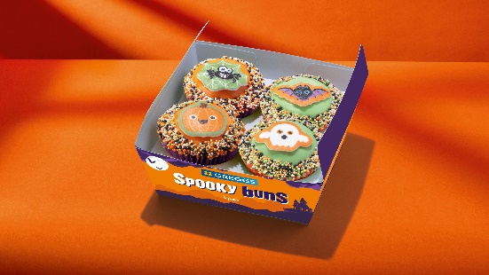 a box of spooky buns with four cupcakes in it