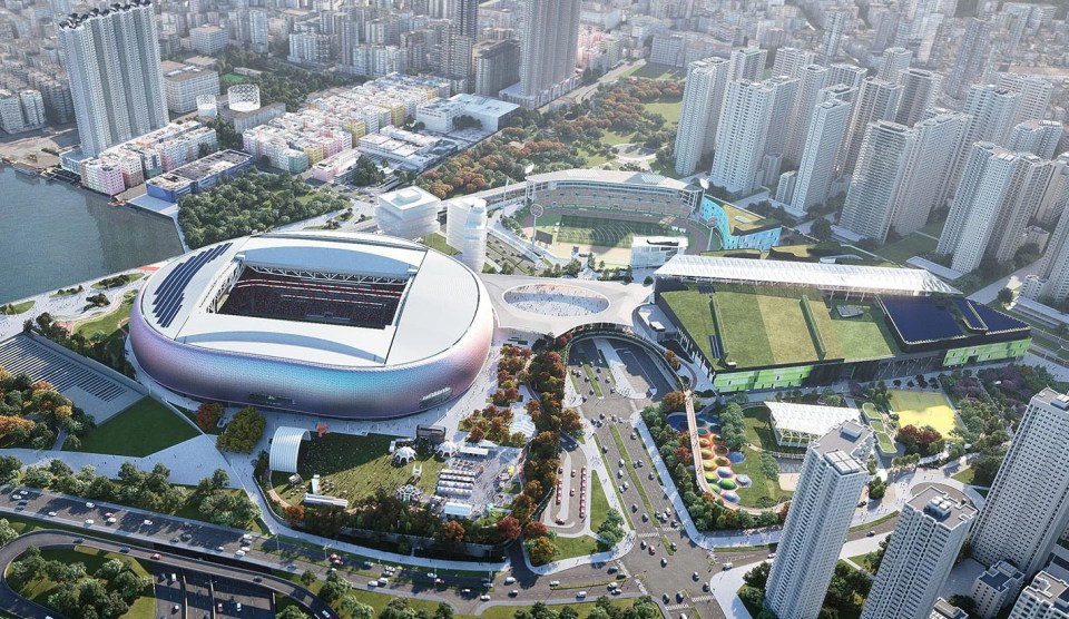 an aerial view of a city with a large stadium in the middle