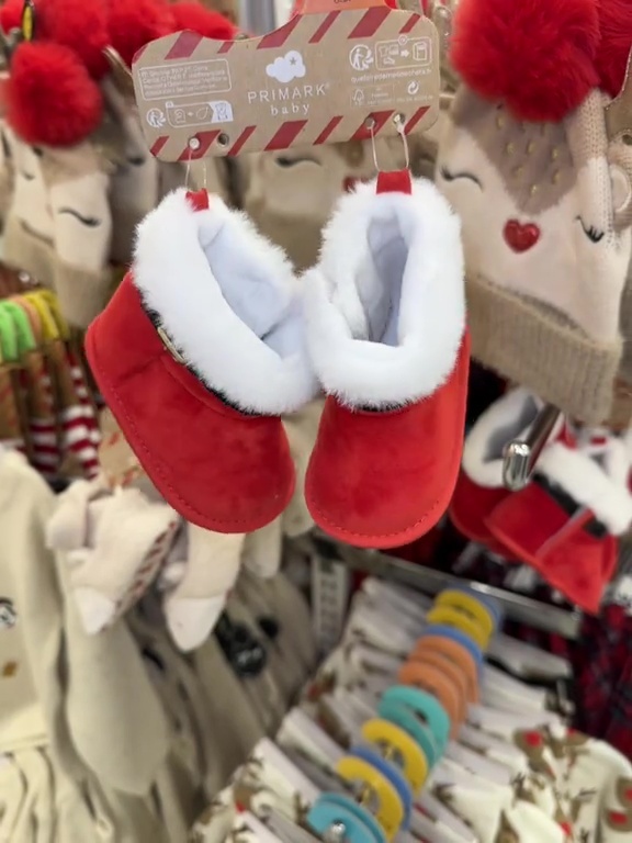 a pair of red and white baby shoes made by primark