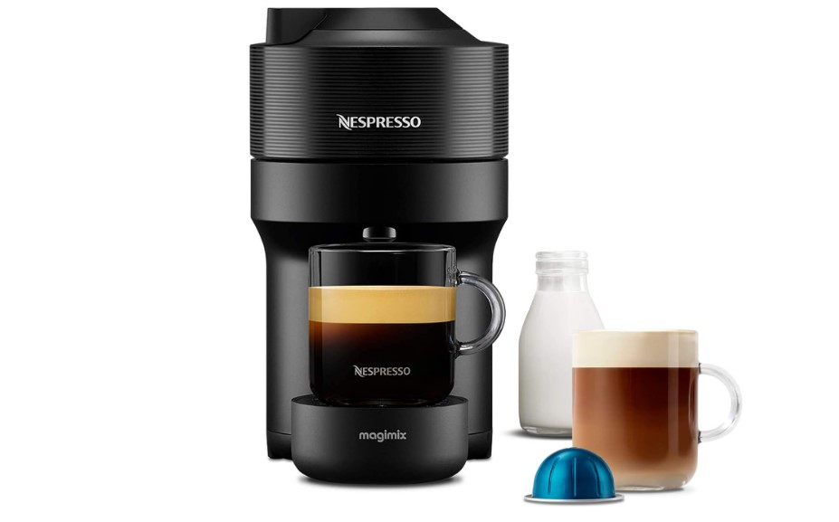 a nespresso machine with a cup of coffee and a bottle of milk