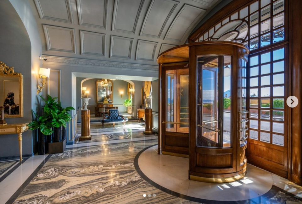 a hotel lobby with a telephone booth in the middle