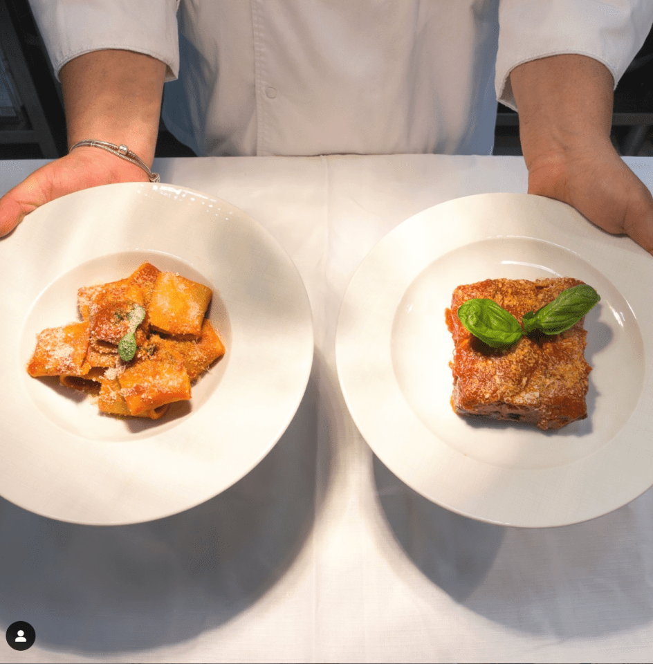 a person is holding two plates of food in their hands