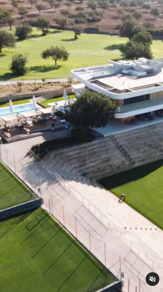 an aerial view of a large house and a soccer field