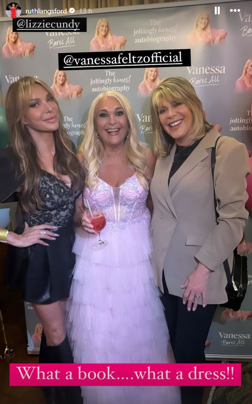 three women pose for a photo in front of a wall that says " what a book what a dress "