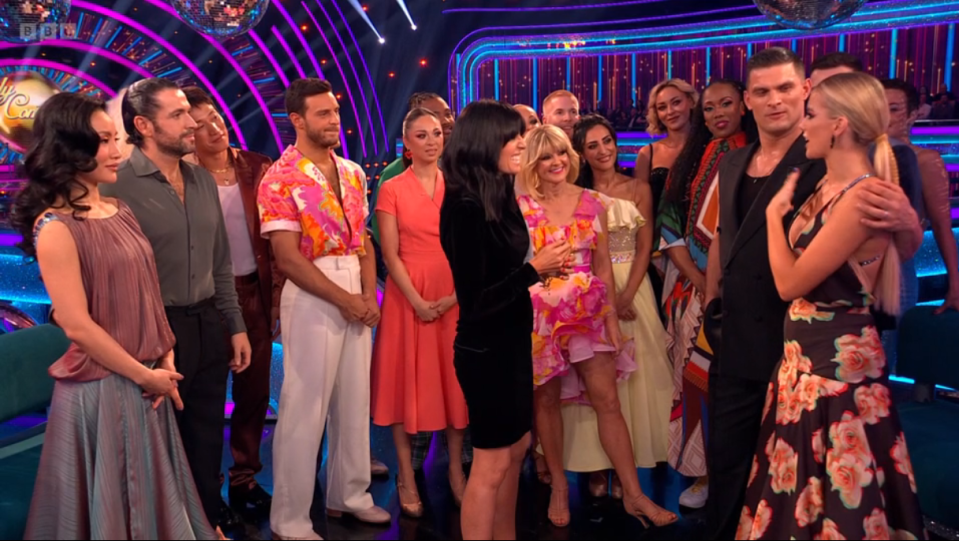 a group of people standing on a stage with a sign that says ' dancing with the stars ' on it