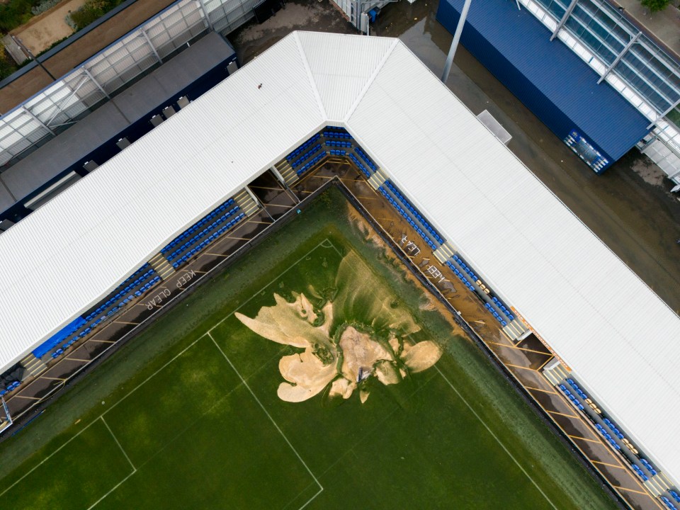 A sinkhole on the pitch and flooded walkways at the Cherry Red Records Stadium, home of AFC Wimbledon in south west London. Parts of Britain have been struck by flash floods after some areas saw more than a month's worth of rain in 24 hours. Heavy rainfall has seen parts of Northamptonshire, Bedfordshire and London submerged causing widespread travel disruption and damage to properties. Picture date: Monday September 23, 2024. PA Photo. Photo credit should read: Jordan Pettitt/PA Wire