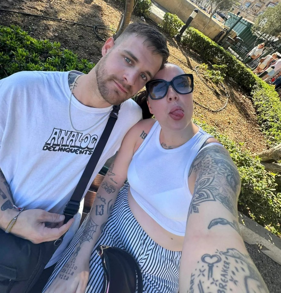 a man and woman are posing for a picture and the man is wearing a shirt that says analog