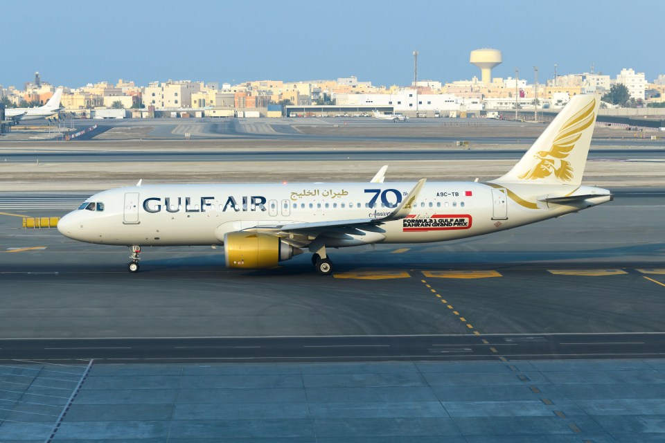 a gulf air plane is sitting on the runway